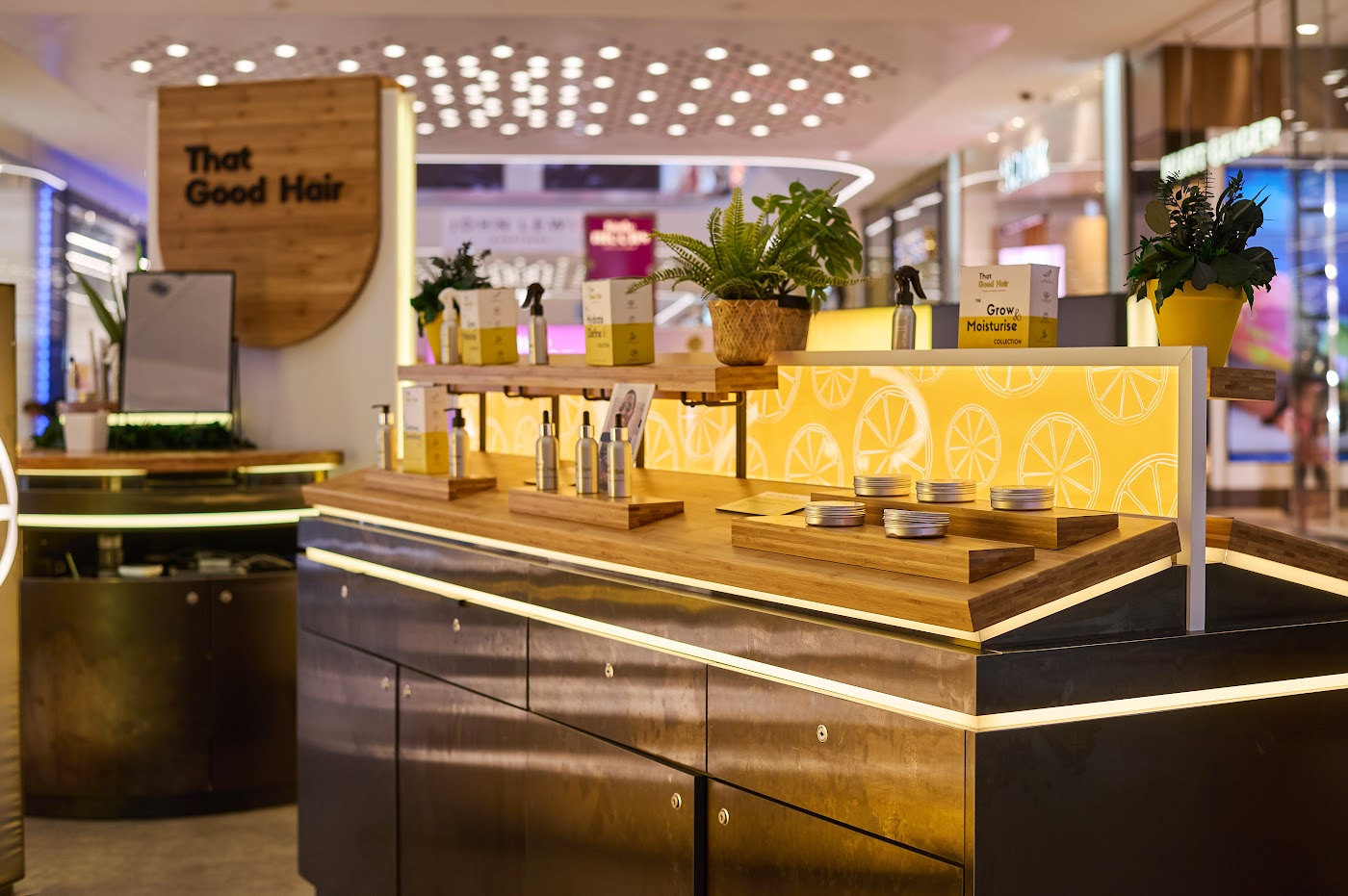 That Good Hair specialist hair products retail kiosk at Westfield London with illuminated timber counter, built by OLLYWOOD